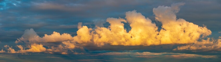 golden clouds after sunset on a dark blue sky