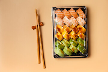 Set of sushi rolls in plastic packages on a light background, top view.