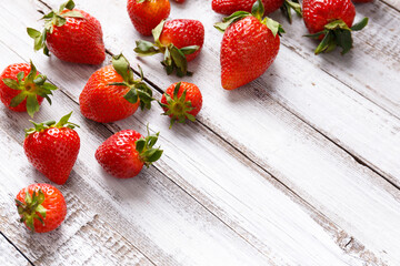 Berries of organic strawberries on a wooden background, copy space.
