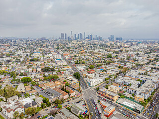 Los Angeles, California – May 23, 2023: aerial drone view toward LA downtown buildings above Rampart Village with Beverly Blvd daytime near Koreatown