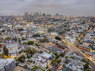 Los Angeles, California – May 23, 2023: aerial drone view toward LA downtown buildings above Rampart Village with Beverly Blvd nighttime near Koreatown - obrazy, fototapety, plakaty