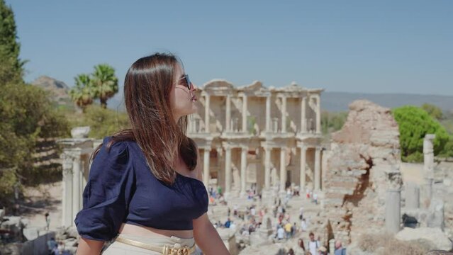 Female tourist visiting Celsus Library in ancient city Ephesus, Anatolia in Selcuk, Turkey. 
