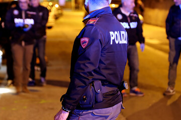 Italian police officers investigating a nighttime murder scene. Italian police at night