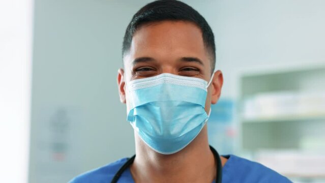 Doctor, man and face mask for healthcare safety, covid or protection from virus at the hospital. Portrait of happy male medical professional with smile covering mouth for sick prevention at clinic