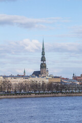 Beautiful view of St. Peter's Cathedral across the Daugava River in Riga, Latvia