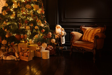 Beautiful Christmas tree, many gift boxes and vintage armchair in room