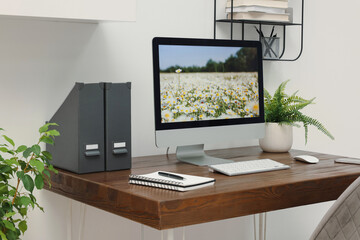 Fototapeta premium Cozy workspace with computer on wooden desk at home