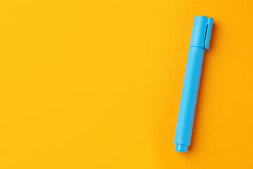 Bright light blue marker on orange background, top view. Space for text