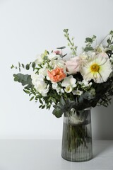 Bouquet of beautiful flowers in vase on white table