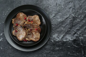 Tasty beef tongue pieces on black textured table, top view. Space for text