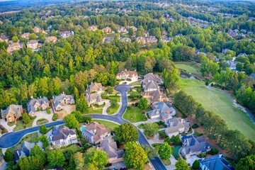 Aerial panoramic view of an upscale subdivision shot during golden hour - obrazy, fototapety, plakaty