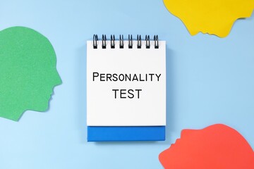 Personality test concept. Word written on blue notepad with human head profile silhouette.	