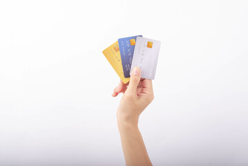 Female hand holding several credit cards on white background.