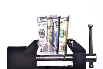 Dollar bills held tight in vise. Business and finance concept.