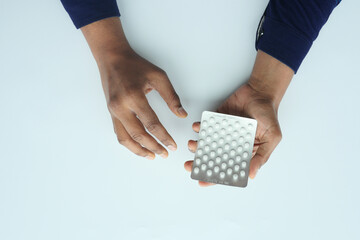  top view of hand holding blister packs .