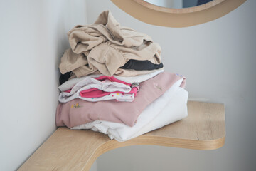 Stack of clothes on table indoor.