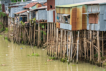 Rustic tin housing raised up on high poles above a river at Chau Doc in Vietnam