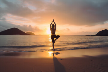 woman doing yoga on the beach at sunset