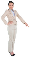 Digital png photo of smiling asian businesswoman pointing finger on transparent background