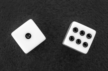 Dices on the black background. Close up. Top view.