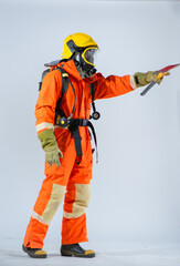 Professional firefighter stands confidently turning sideways as he grip an iron axe poised with determination while facing forward on a white background.