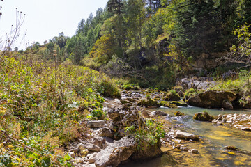 Autumn in a mountainous area, a shallow river and a leisurely flow of water, causing nostalgia for...