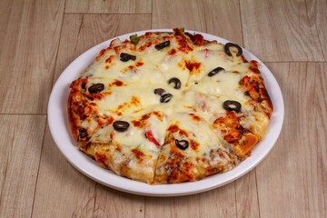 chicken barbecue pizza in plate on wooden background.
