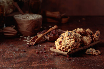 Oatmeal raisin cookies on a brown table.