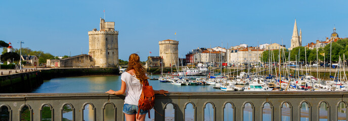 Woman tourist visiting La Rochelle city- Charente Maritime in France - obrazy, fototapety, plakaty