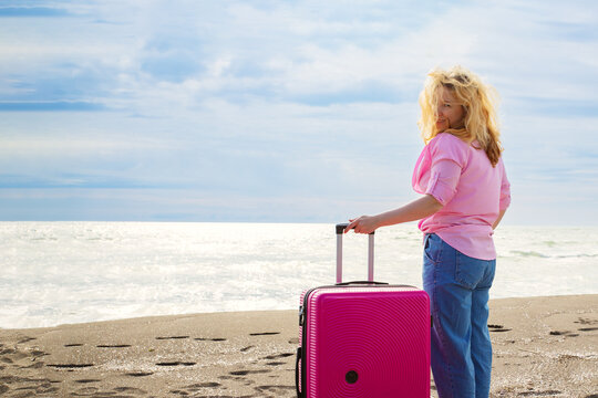 Woman with luggage enjoying the beach view, Beach holiday