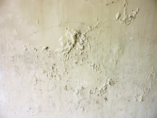 Wet ceiling due to heavy rain. Leaking roof and damp wall. Big wet spots and cracks on the ceiling of the house room 