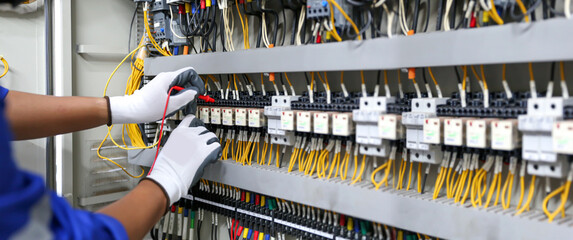 Electricity and electrical maintenance service, Engineer hand checking electric current voltage at...