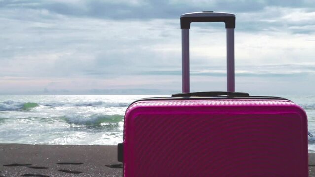Suitcase on the sand, travel, tourism and vacation, baggage by the ocean,