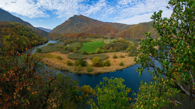 A mountain above a river meander in autumn