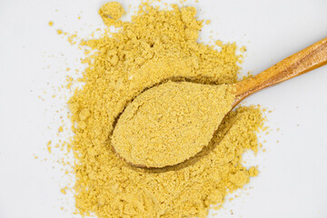 Ginger powder isolated on white background. Ginger powder in wooden spoon