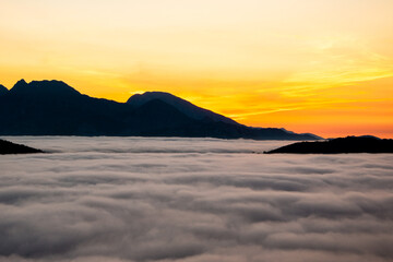 Sea of ​​clouds at sunset on the mountain