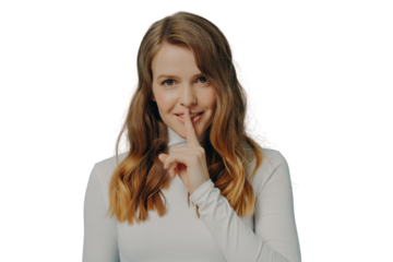 Smiling young millennial woman holding index finger on her lips over blue studio wall background