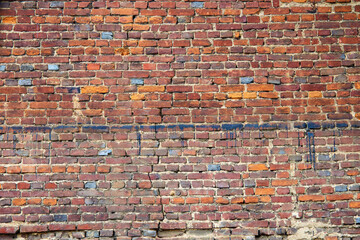 Abstract red brick old wall texture background. Ruins uneven crumbling red brick wall
