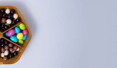 Candies. Assorted colored chocolate dragee. Desserts for candy bars. Small dragees. white background.