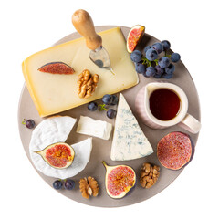 Cheese plate isolated on white background. Different cheese served with nuts, fruits and honey. Cheese platter. Top view.