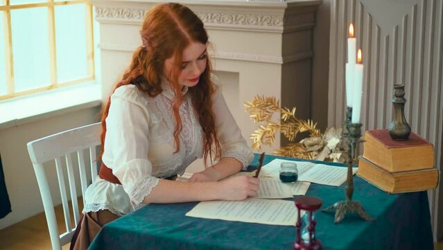 Medieval lady fantasy woman holds pen feather quill in hands close-up. Girl princess sits at desk writes love letter on sheet paper. Vintage dress old books. student studying in classic style old room