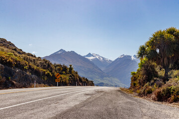 Drive towards the Haast Pass, NEw Zealand, with now-topped mountains