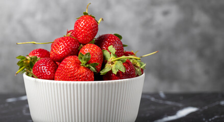 Strawberry in bowl. Organic farm products. Fresh strawberries on dark background. Copy space. Empty space for text