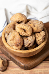 Dried figs in bowl. Organic farm products. Sun-dried figs on dark background. Close up