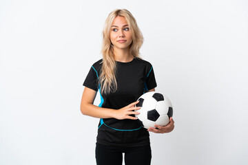 Young Russian woman playing football isolated on white background making doubts gesture looking side