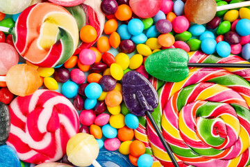 Fototapeta na wymiar Sweet lollipops and candies as background, closeup