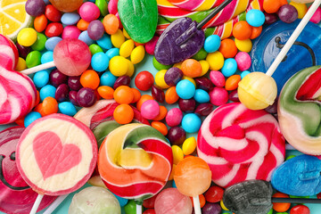 Sweet lollipops and candies as background, closeup