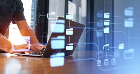 Man using laptop in office, DMS interface