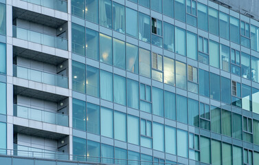 Abstract reflection of modern city glass facade. Office building glass wall