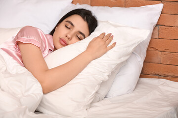 Obraz na płótnie Canvas Young woman sleeping on soft pillow in bedroom, closeup